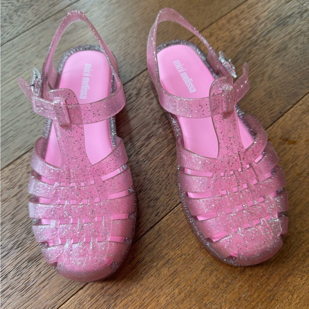 Gently used pink glitter Melissa possesion jellies for girls. Size 2.